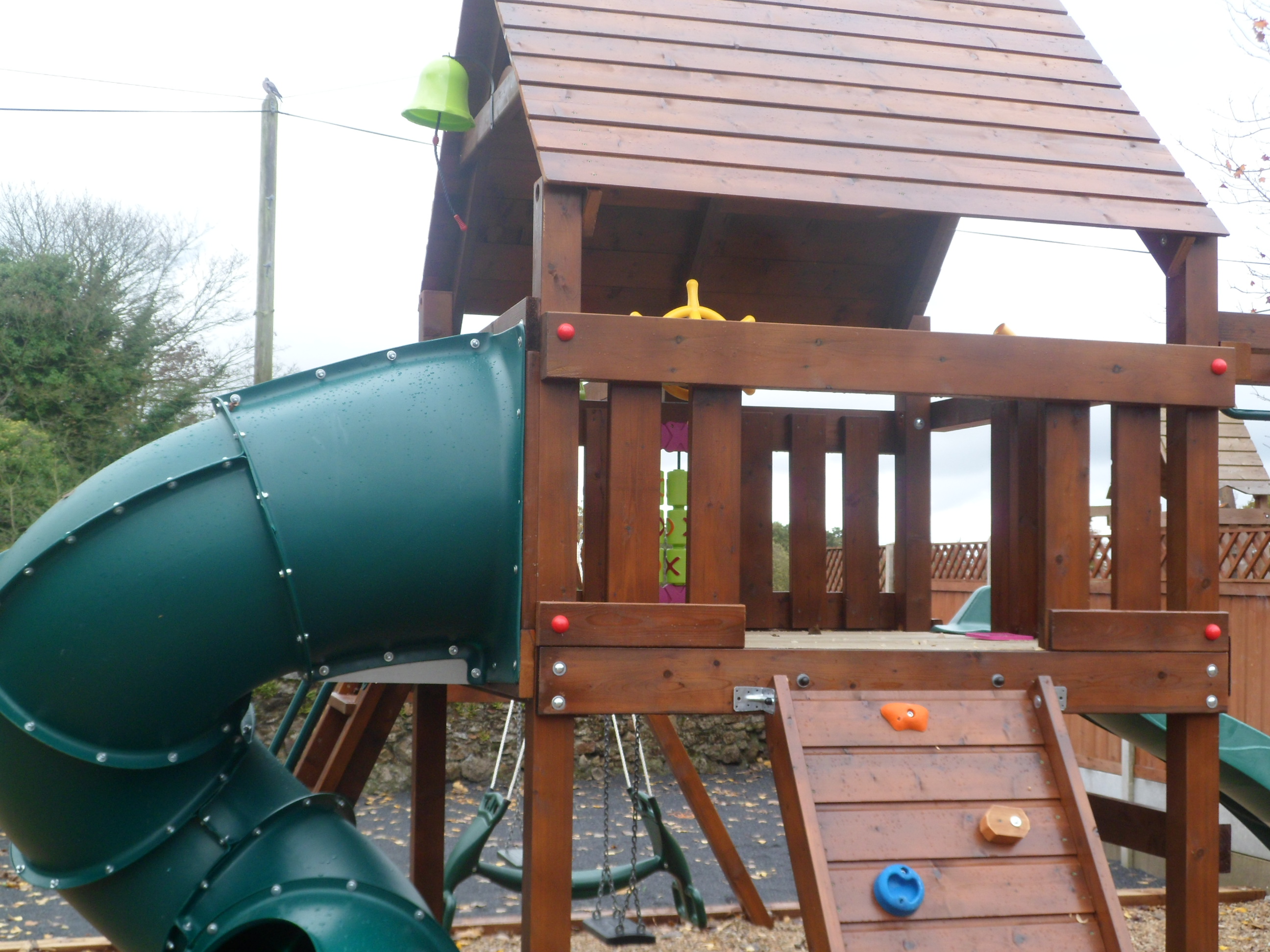 Spiral tube slide birds nest swings vertical rockwall monkeybars playhouse